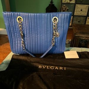 Bvlgari blue lambs leather pleated purse with dust cover and rain cover.